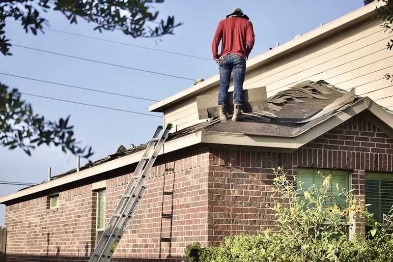 Professional roofer working on a residential roof in Treharne